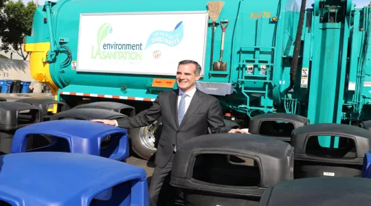 mayor with trash cans and a truck