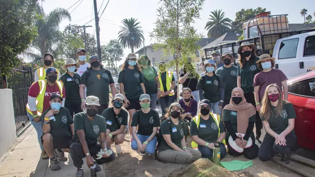 Tree Ambassadors and City Plants Program Coordinator pose by newly planted street tree