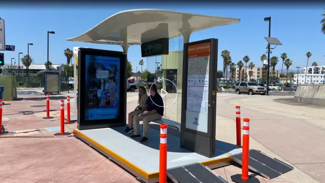 This is a screenshot of a video from Spectrum news discussing LA's new bus shelter designs